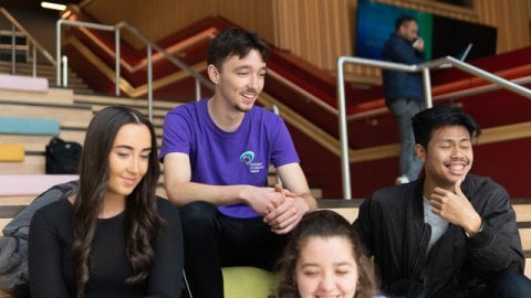 Students sitting on steps on university campus