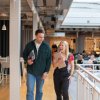 Two employees in the workplace communal area