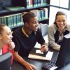 Students looking at computer screen in a library